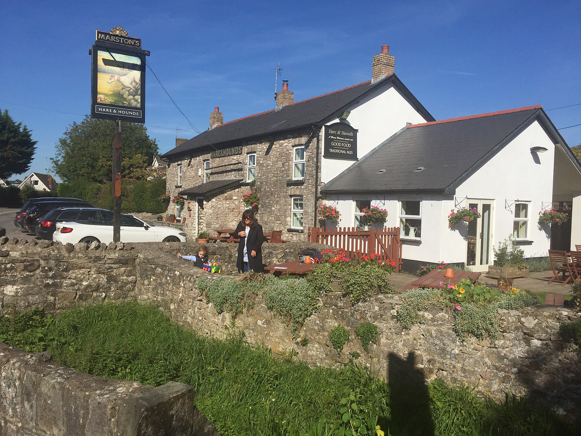 The Hare and Hounds pub in Aberthin, a white and stone building with a garden.