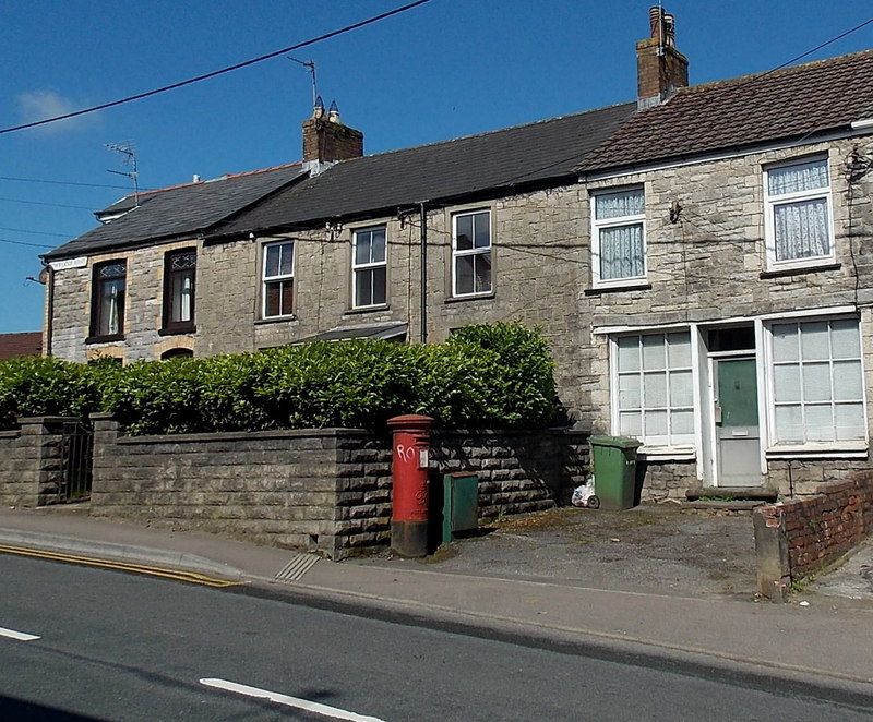 A terrace of stone houses in Brynsadler, the former post office, with a red post box.