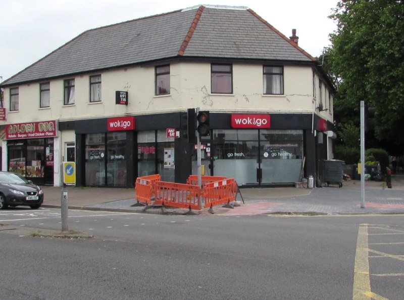 A corner building with a WokToGo restaurant at a road junction in Birchgrove.