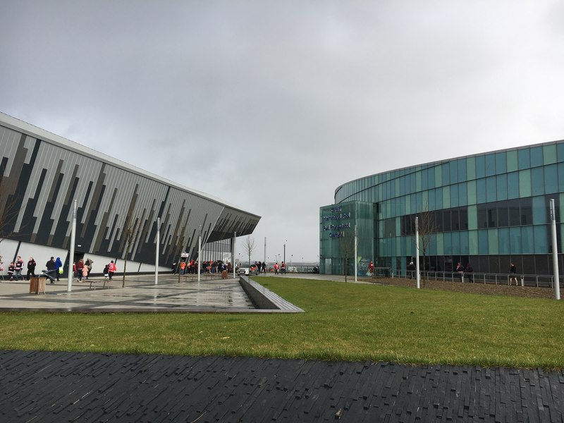 Cardiff International Pool and Ice Arena Wales, two modern buildings across a lawn.