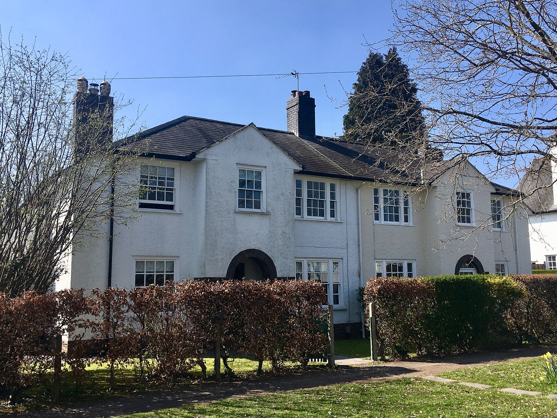 Listed white-rendered houses on Lon-y-dail in Rhiwbina Garden Village.