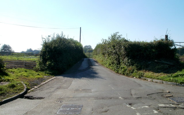 Church Road heading away from Bridge Road between hedges.