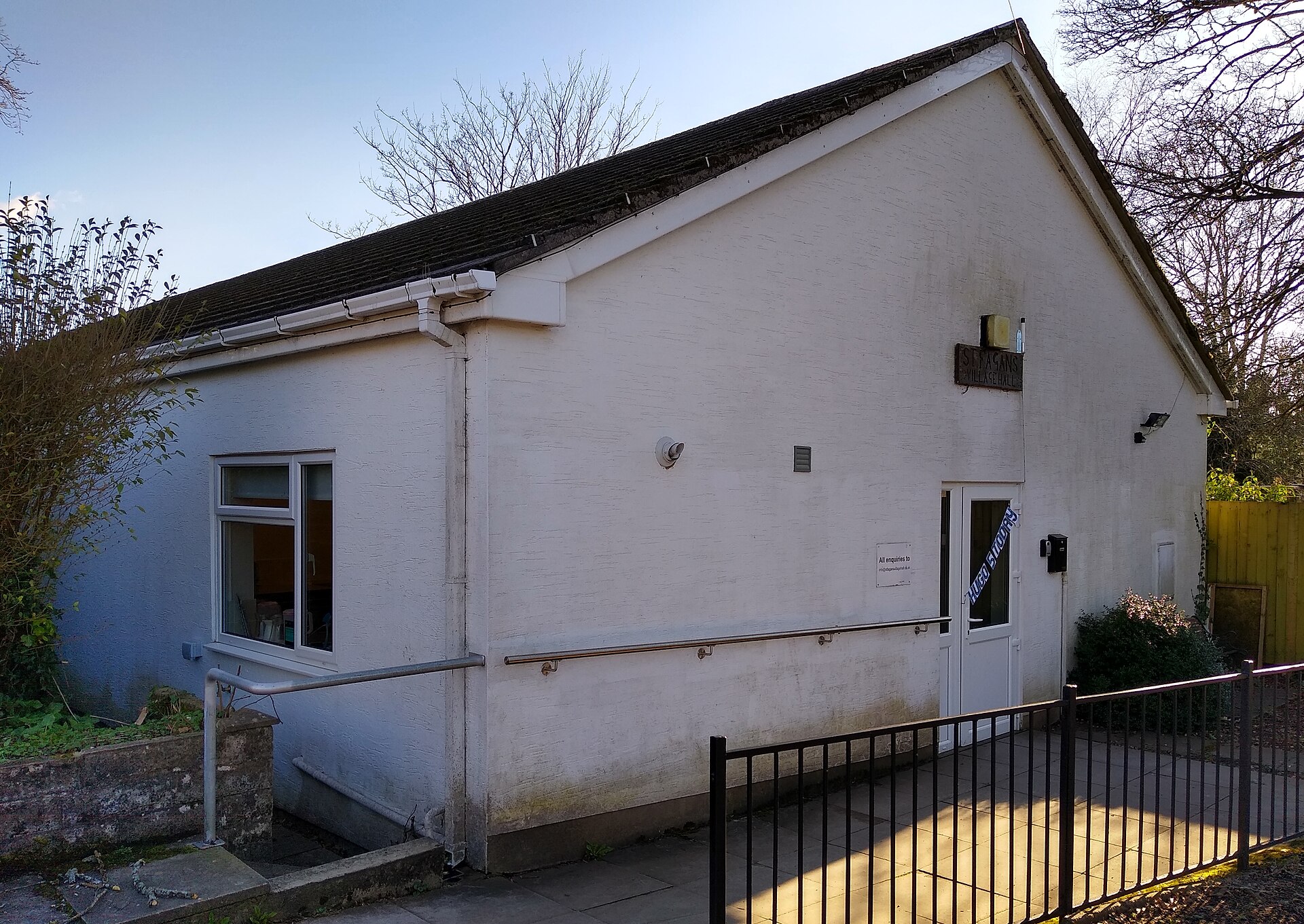 St Fagans Village Hall, a white single-storey building behind railings.