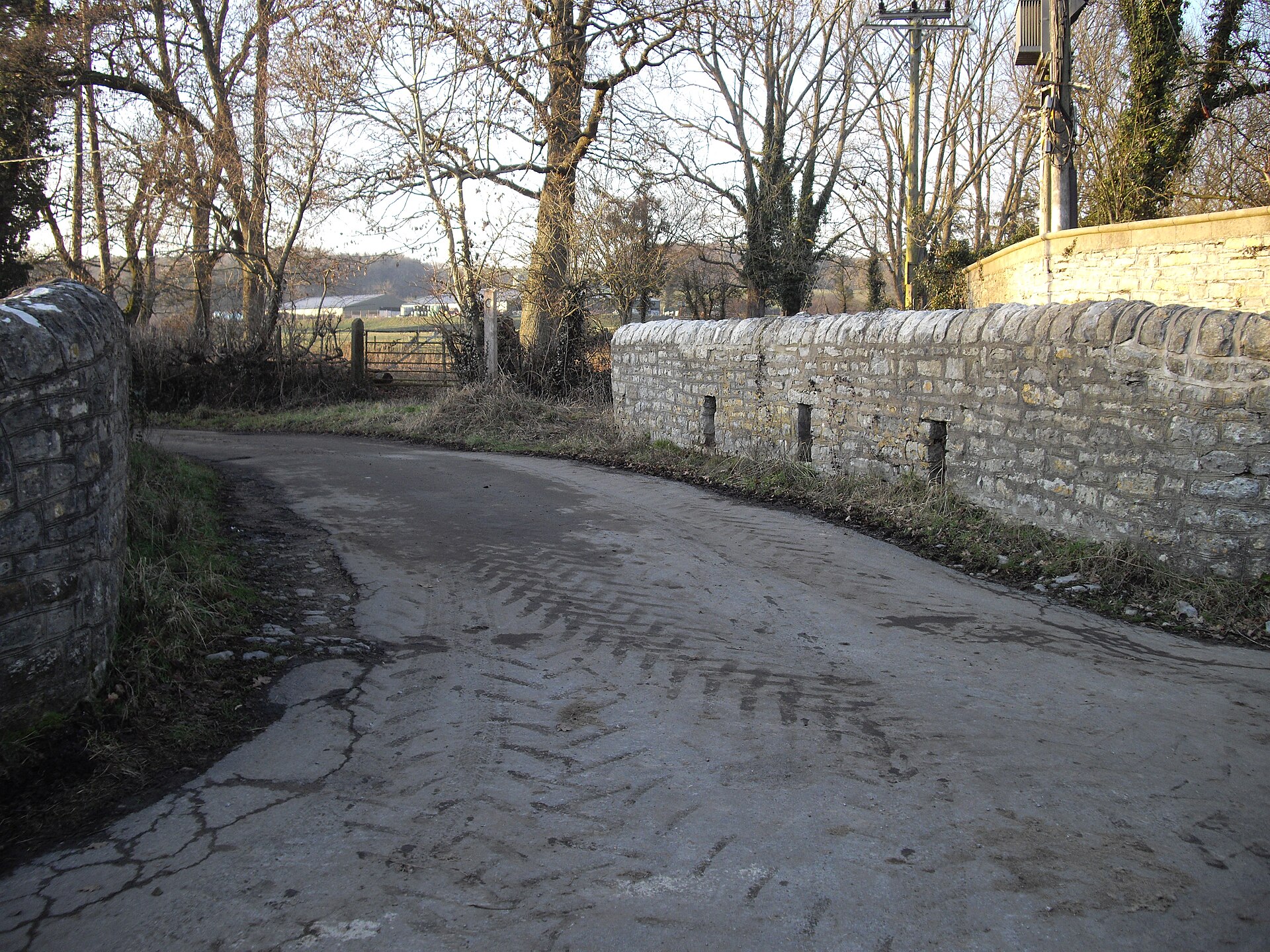 A lane between stone walls at the bridge over the River Waycock in Dyffryn.