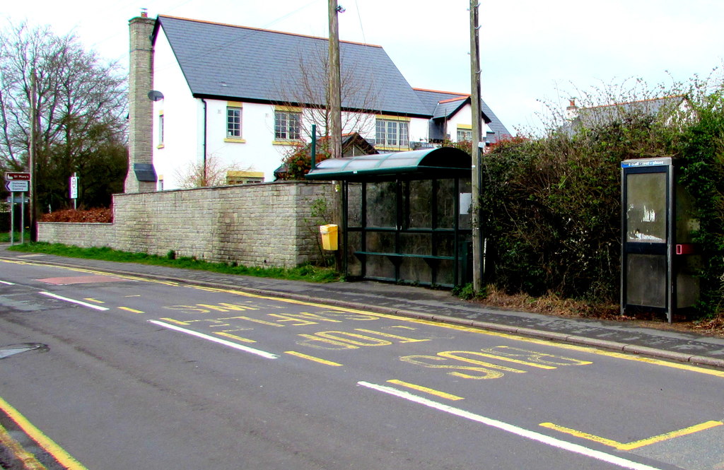 A phone box and bus shelter beside Marshfield Road in Marshfield.