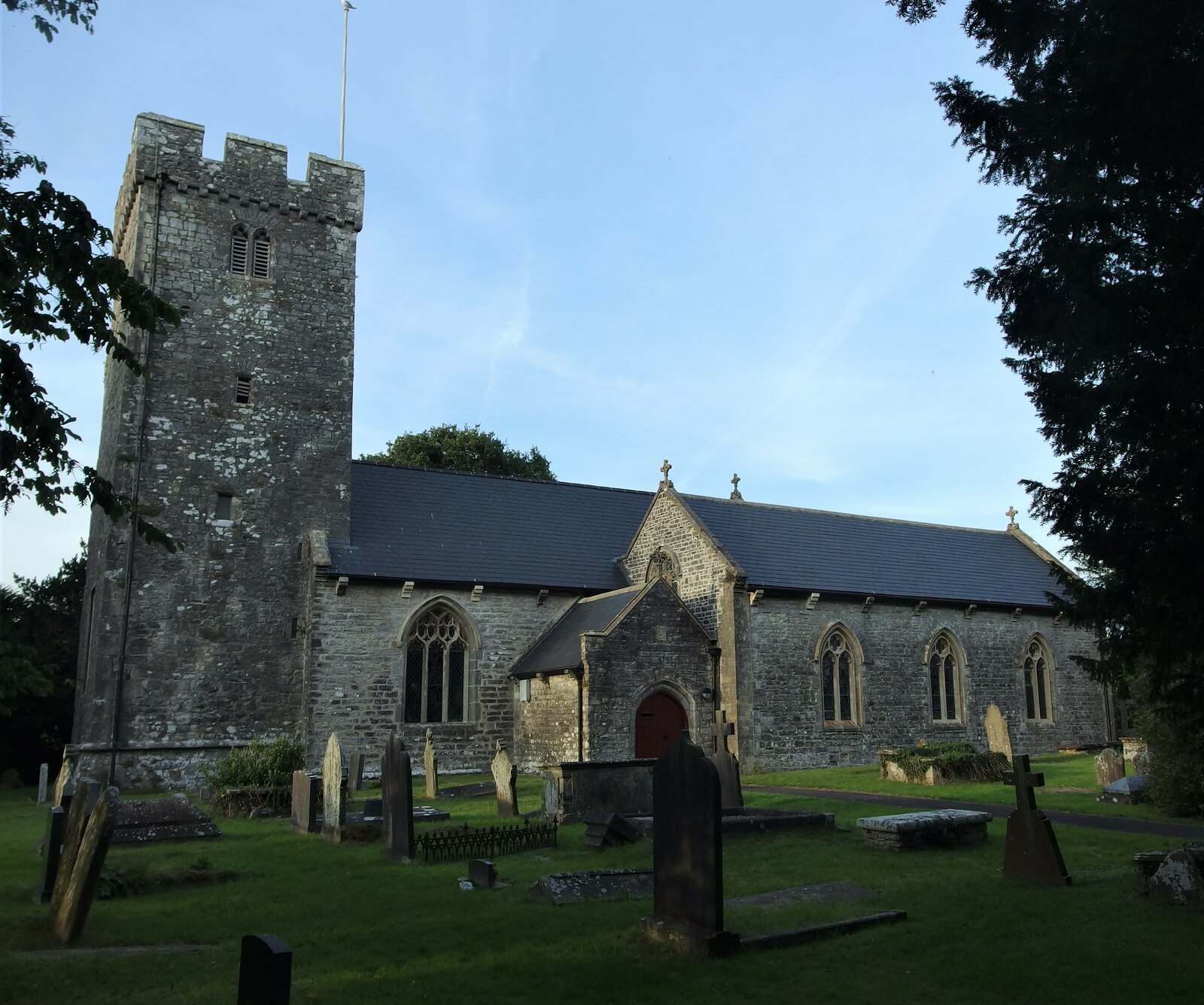The Parish Church of St Nicholas, a stone church with a battlemented tower.
