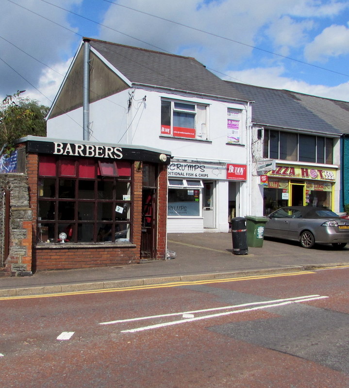Talbot Road Barbers and neighbouring shops on a street corner in Talbot Green.
