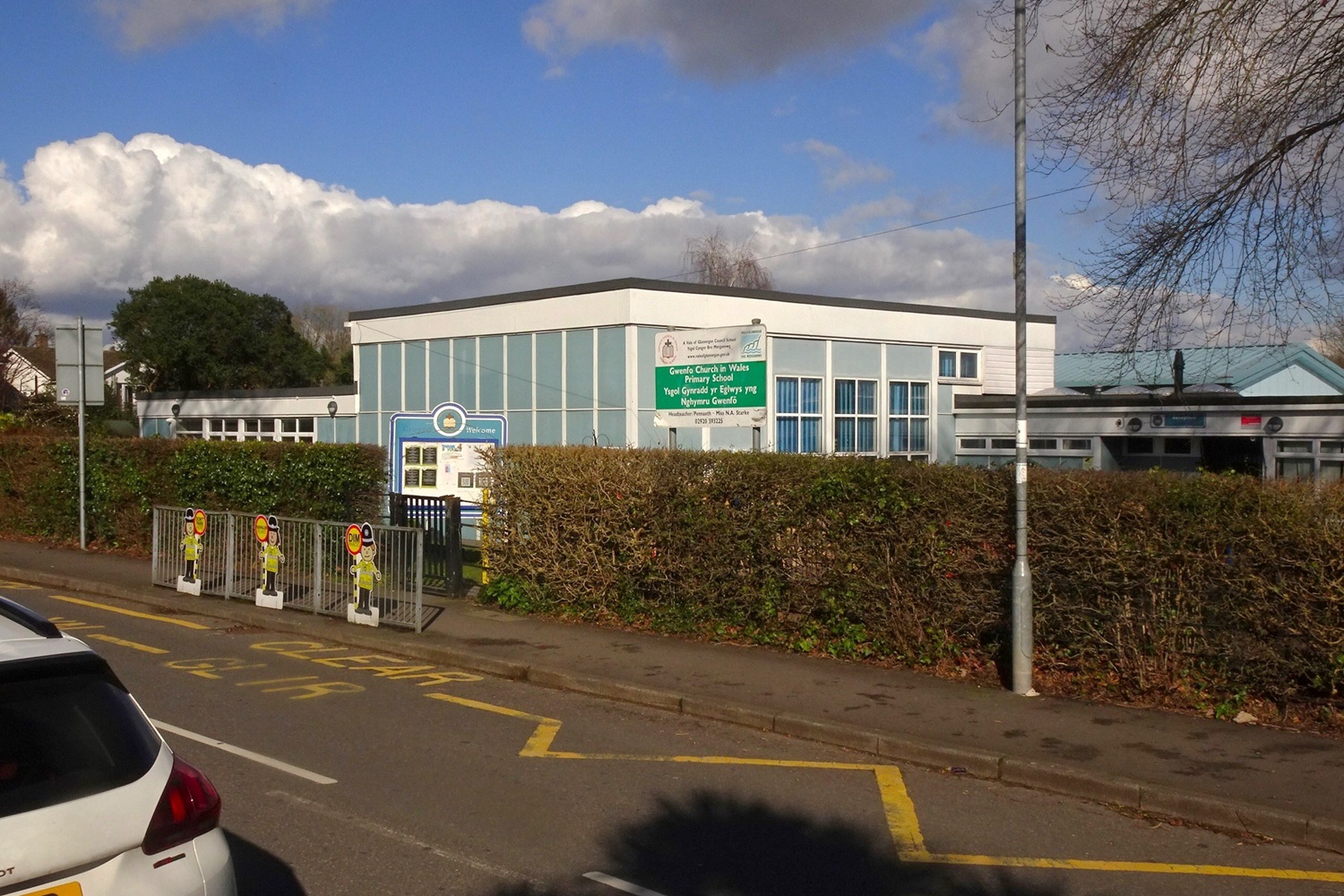 The primary school in Wenvoe behind a hedge and school railings.